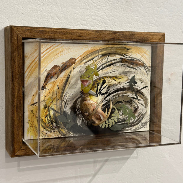 Mixed media diorama scene of a small green frog slaying a large monstrous fish with a knife, splaying the fish's guts over the scene.
