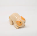  Ceramic sculpture of cream colored with orange spots cat on all fours, leaning with its head tilted as though ready to be petted. It has 2 tails.