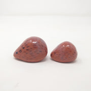 2 small, simplistic rounded sculptures of brown hedgehogs. They have painted on spikes and simple expressions.