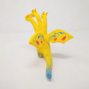 Sculpture of King Ghidorah, with 3 long necks and a set of small wings. It is painted yellow with a floral motif on its stomach. Each face has a different expression.