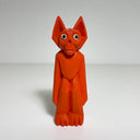 Carved and painted wooden sculpture of an all red goblin, with very long arms and legs and pointed ears. Its face lightly resembles a monkey, with large eyes.