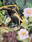Diorama made of clay and paper of a character napping in a wooden structure in a tree, alongside a napping raccoon. Around them are flowers and a tiny hedgehog family with 3 babies.