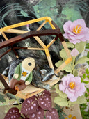 Diorama made of clay and paper of a character napping in a wooden structure in a tree, alongside a napping raccoon. Around them are flowers and a tiny hedgehog family with 3 babies.