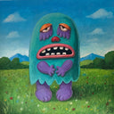 Colorful monster in a grassy field with mountains and sky in the background