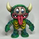 Colorful monster figurine with horns and a large tongue on a light gray background