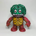 Vinyl figure of a red and yellow monster with a green head, shaped and textured like a brain.