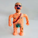 Novelty toy figure with text and patterns on a plain background