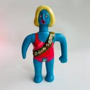 Colorful action figure with a blue body, red top, and yellow hair on a white background