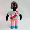 Toy figure with a gray shirt and pink pants on a white background