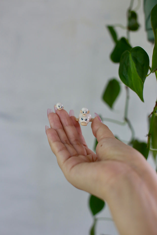 Set of 3 small ceramic sculptures of ducks, with cute sparkly eyes and pink cheeks.