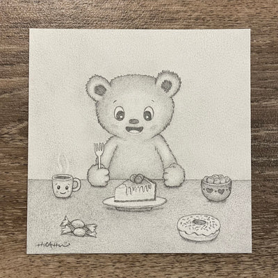 Graphite drawing of a cartoon bear, smiling and sitting at a table with a fork in hand. On the table is a slice of cake, a donut, a mug and candy.