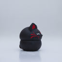 Black clay pot with a lid that looks like a fox's head, a matching black color with red ears and face paint. It has closed eyes and a small white nose. The bowl has no body details.