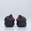 Black clay pot with a lid that looks like a fox's head, a matching black color with red ears and face paint. It has closed eyes and a small white nose. The bowl has no body details.