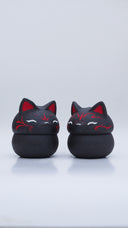 Black clay pot with a lid that looks like a fox's head, a matching black color with red ears and face paint. It has closed eyes and a small white nose. The bowl has no body details.