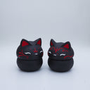 Black clay pot with a lid that looks like a fox's head, a matching black color with red ears and face paint. It has closed eyes and a small white nose. The bowl has no body details.