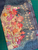 Neoprene desk mat with a colorful illustration of fantasy characters having an outdoor party with food and music, under string lights.