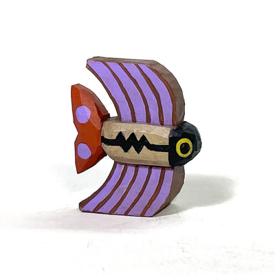 Small painted whittled wooden sculpture of a fish with tall fins, striped brown and purple. The body is tan with a Charlie Brown esque stripe.