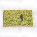 Painting on a slightly ripped piece of canvas based on a film still from Big Fish, of a man in a suit standing in a field with tall grass, coming up to his knees.