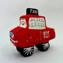 Clay sculpture of a cartoon style taxi red in coloring with a cute smiley face.