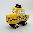Clay sculpture of a cartoon style taxi, yellow in coloring with a cute smiley face.