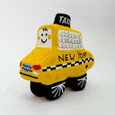 Clay sculpture of a cartoon style taxi, yellow in coloring with a cute smiley face.