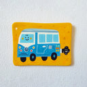 A flat artwork featuring a hand-painted illustration of a blue and white smiling VW camper van, displayed on a textured white wall.