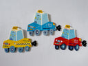 3 flat sculptures of cartoon style taxis with cute smiley faces and a cartoon plume of exhaust smoke coming out the tailpipe.