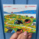 Painting of a small village in a grassy seaside area, with a lighthouse.