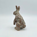 Ceramic rabbit figurine on a light gray background