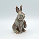 Ceramic rabbit figurine on a light gray background