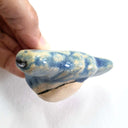 Ceramic sculpture of a hammerhead shark's head, with a blue with tan coloring and a cream colored underside.