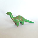 Green dinosaur figurine on a white background