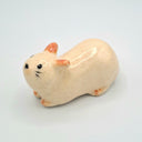 Ceramic cat figurine on a light gray background