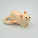 Ceramic cat figurine on a light gray background