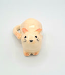 Ceramic cat figurine on a light gray background