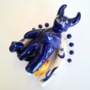 Blue ceramic oni sculpture on a white background