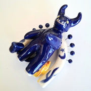 Blue ceramic oni sculpture on a white background