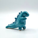 Blue dinosaur figurine on a white background