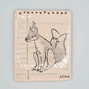 A rectangular ceramic tile featuring a hand-drawn sketch of a kitsune fox on a lined paper background, signed 'J. LIMA' in the bottom right corner, set against a solid light gray background.