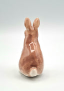 Brown ceramic bunny sculpture.