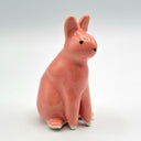 Red ceramic rabbit sculpture.