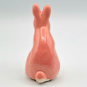 Red ceramic rabbit sculpture.