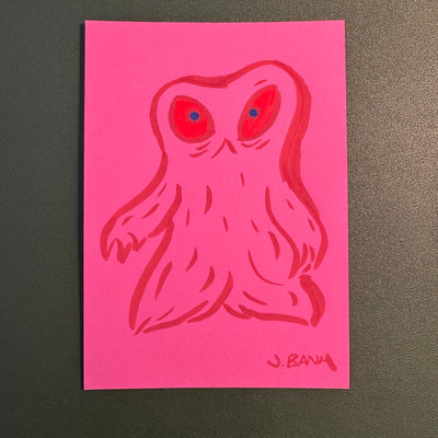 Marker illustration on neon pink paper of a blob monster with 2 red eyes.