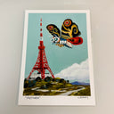 Illustration of Mothra flying past Tokyo Tower on a light blue background