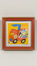 Painting of a cartoon girl with a devil hood on, driving an apple shaped car with stickers all over it.