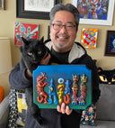 Bluish green wooden plaque with 3D raised parts atop it, spelling out "Kaiju." The parts are all various monsters and each colored individually. Held by the artist.