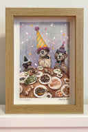 Colored pencil illustration of 2 dogs, different sizes though all fluffy and brown, sitting at a table with various Korean bbq style foods in front of them. They each wear a party hat with frills and confetti coming down.