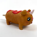 Sculpture of a corn dog, designed to look like a dog with a cute, silly face and a metallic unicorn horn atop its head. It has a squiggle of ketchup on its back.