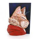 3D sculpture of the profile view of an orange cat, wearing a red hoody. It is attached to a flat dark blue wood panel.