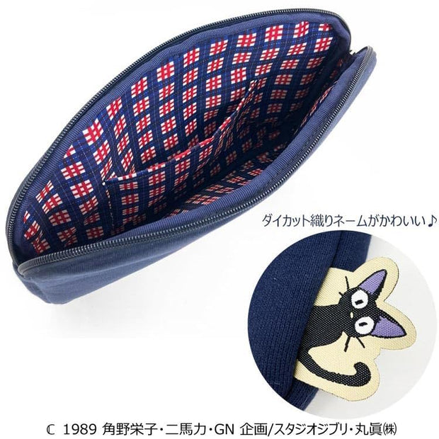 Inside view of pouch, lined with a red white and navy blue plaid fabric. On the side of the bag is a a die cut embroidery of Jiji the cat sticking its head out.
